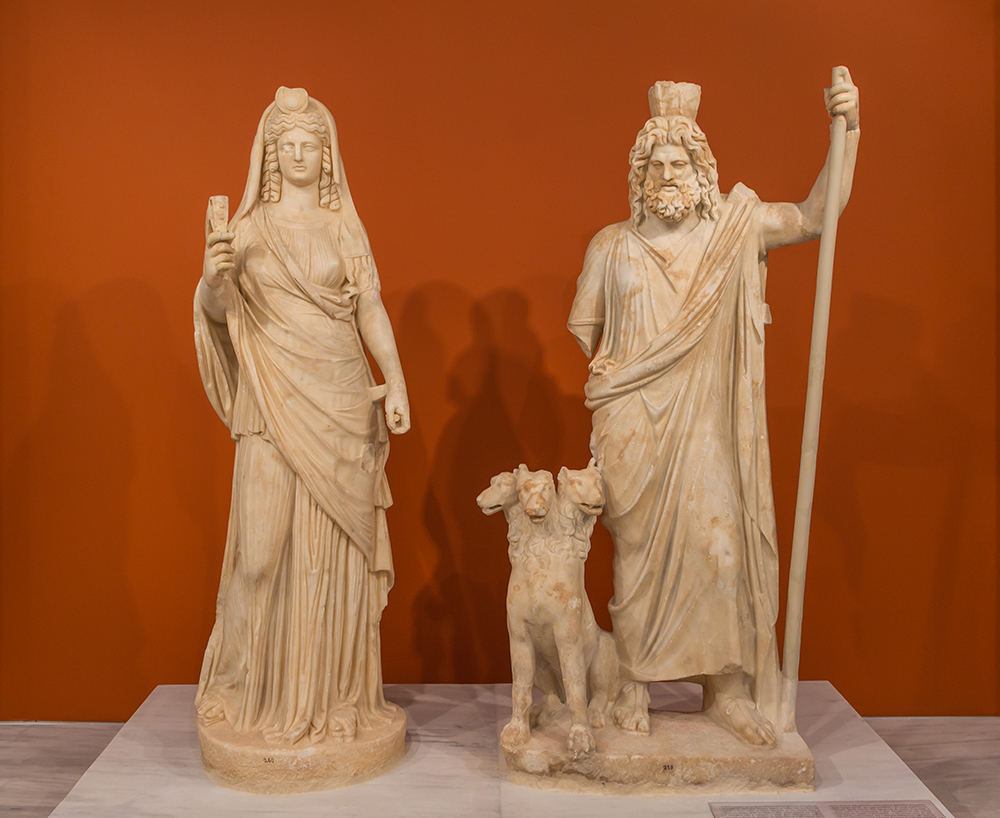 Group of ancient Roman statues of Persephone (as Isis), Cerberus, and Pluto (as Serapis). Wikimedia Commons, Archaeological Museum of Heraklion.