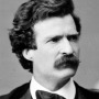 Black and white photograph of a young Mark Twain with dark hair.